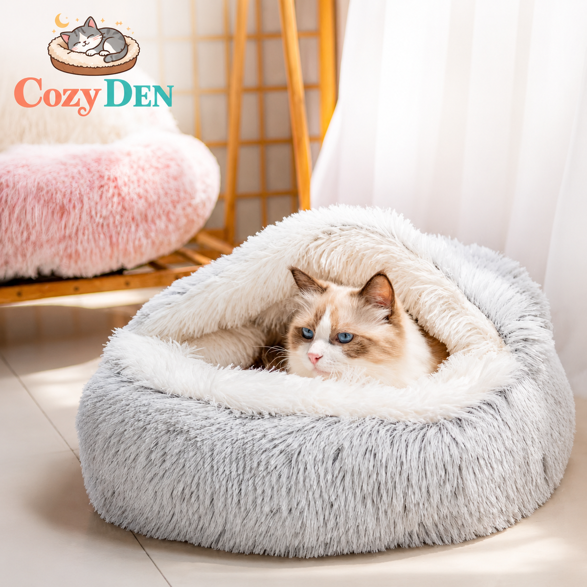 Cat lying in a fluffy gray pet bed with 'Cozy Den' branding.
